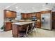 Updated kitchen with granite countertops, wood cabinets, stainless steel appliances and island with barstool seating at 1226 Debuel Rd, Lutz, FL 33549