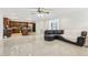 Open-concept living room with a modern kitchen, tile floors, and a comfortable seating area at 1226 Debuel Rd, Lutz, FL 33549