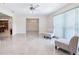 Bright living room with tile flooring, ceiling fan, and sliding glass doors providing natural light at 1226 Debuel Rd, Lutz, FL 33549