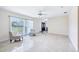 Open living room featuring tile floors, a ceiling fan, and a double door entrance at 1226 Debuel Rd, Lutz, FL 33549