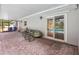 Covered patio overlooking pool with ample seating, kayak, and paver flooring at 1226 Debuel Rd, Lutz, FL 33549