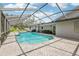 Outdoor pool and lanai area featuring pavers, ample space for relaxing, and private backyard at 1226 Debuel Rd, Lutz, FL 33549
