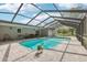 Enclosed pool area with brick pavers and a view of the yard at 1226 Debuel Rd, Lutz, FL 33549