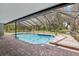 Screened in pool with pavers, lanai area, and view of backyard at 1226 Debuel Rd, Lutz, FL 33549