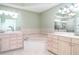 En-suite bathroom featuring double sinks, large soaking tub, and tile flooring at 1231 Corinth Greens Dr, Sun City Center, FL 33573
