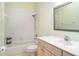 Cozy bathroom features a shower-tub combo and a standard vanity with sink and mirror at 1231 Corinth Greens Dr, Sun City Center, FL 33573
