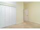 This bedroom is bright and spacious with double bi-fold closet doors, and neutral carpet at 1231 Corinth Greens Dr, Sun City Center, FL 33573