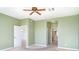 Bedroom features a view to an en-suite bathroom with neutral walls and carpet flooring at 1231 Corinth Greens Dr, Sun City Center, FL 33573