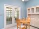 Cozy dining area with a view to the outdoors, cabinet and table at 1231 Corinth Greens Dr, Sun City Center, FL 33573