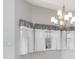 Chandelier shines over dining area with sheer curtains and natural light at 1231 Corinth Greens Dr, Sun City Center, FL 33573