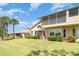 Charming home boasts screened balcony, manicured lawn and lush tropical landscaping at 1231 Corinth Greens Dr, Sun City Center, FL 33573