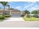 Charming single-story home featuring a two-car garage, brick paver driveway, and well-maintained landscaping at 1231 Corinth Greens Dr, Sun City Center, FL 33573