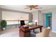 Inviting home office with a lovely desk, ceiling fan, and an upper loft area at 1231 Corinth Greens Dr, Sun City Center, FL 33573
