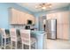 Bright kitchen with a breakfast bar, stainless steel appliances, and stylish cabinets at 1231 Corinth Greens Dr, Sun City Center, FL 33573