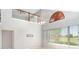 Bright, open living area with a large window and cathedral ceilings at 1231 Corinth Greens Dr, Sun City Center, FL 33573
