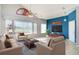 Bright living room with large windows, comfortable seating, and a stylish entertainment center at 1231 Corinth Greens Dr, Sun City Center, FL 33573