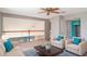 Bright loft area features seating, a ceiling fan and balcony overlooking the living area below at 1231 Corinth Greens Dr, Sun City Center, FL 33573