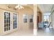 Screened-in porch offering a comfortable seating area with an outdoor ceiling fan at 1231 Corinth Greens Dr, Sun City Center, FL 33573