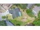 Aerial shot of a home with pool and fenced yard near a tranquil lake at 12317 Smokey Dr, Hudson, FL 34669