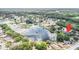 Scenic aerial view of a neighborhood surrounding a pond and lush greenery at 12317 Smokey Dr, Hudson, FL 34669