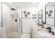 Modern bathroom featuring a dual sink vanity, walk-in shower with pebble floor, and stylish fixtures at 12317 Smokey Dr, Hudson, FL 34669