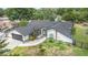 Charming single-story home with a well-manicured lawn, mature trees, and a two-car garage at 12317 Smokey Dr, Hudson, FL 34669