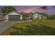 Charming single-story home featuring a well-manicured lawn and a two-car garage at 12317 Smokey Dr, Hudson, FL 34669