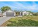 Charming single-story home featuring a well-manicured lawn and a two-car garage at 12317 Smokey Dr, Hudson, FL 34669