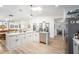 Modern kitchen featuring an island with a marble countertop and stainless steel appliances at 12317 Smokey Dr, Hudson, FL 34669