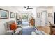 Bright living room featuring a recliner, area rug, piano, and sliding glass doors to the pool area at 12317 Smokey Dr, Hudson, FL 34669