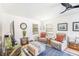 Cozy living room with comfortable seating, natural light, and hardwood floors at 12317 Smokey Dr, Hudson, FL 34669