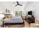 Spacious main bedroom with a large bed, dresser, ceiling fan and access to the backyard at 12317 Smokey Dr, Hudson, FL 34669