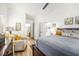Bright main bedroom with a ceiling fan, ensuite bathroom, and a comfortable chair at 12317 Smokey Dr, Hudson, FL 34669