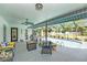 Spacious screened-in patio with a fire pit, comfortable seating, and a swimming pool at 12317 Smokey Dr, Hudson, FL 34669