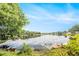 Scenic view of the tranquil pond reflecting the sky, surrounded by trees at 12317 Smokey Dr, Hudson, FL 34669