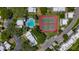 Aerial view of community featuring a pool, tennis courts, and well-maintained landscaping at 1241 N Mcmullen Booth Rd, Clearwater, FL 33759