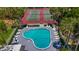 An aerial view featuring a swimming pool and tennis courts at 1241 N Mcmullen Booth Rd, Clearwater, FL 33759