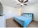 Comfortable bedroom with blue bedding, soft carpeting, and a wall-mounted television at 1241 N Mcmullen Booth Rd, Clearwater, FL 33759