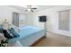 Bedroom with neutral carpet, television, natural light from the windows, and bright walls at 1241 N Mcmullen Booth Rd, Clearwater, FL 33759