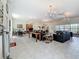 Spacious clubhouse featuring a seating area, dining tables, chandeliers, and ample natural light at 1241 N Mcmullen Booth Rd, Clearwater, FL 33759