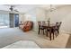Cozy dining area with a wooden table, seating for four, and a sliding glass door to the outside at 1241 N Mcmullen Booth Rd, Clearwater, FL 33759