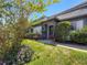 Charming home with lush landscaping, mature trees, and a well-manicured lawn at 1241 N Mcmullen Booth Rd, Clearwater, FL 33759