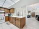 Bright kitchen showing wood cabinets, white countertops, and an open layout into the dining area at 1241 N Mcmullen Booth Rd, Clearwater, FL 33759