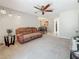 Comfortable living room with plush seating, ceiling fan, and a view into the adjacent dining area at 1241 N Mcmullen Booth Rd, Clearwater, FL 33759