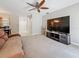 Bright living room featuring neutral walls, ceiling fan, and a large entertainment center at 1241 N Mcmullen Booth Rd, Clearwater, FL 33759