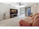 Inviting living room with a large TV, sliding door to the patio, and neutral-colored walls at 1241 N Mcmullen Booth Rd, Clearwater, FL 33759