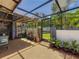 Enclosed patio with clear roof, featuring plants, a bicycle, seating, and outdoor access at 1241 N Mcmullen Booth Rd, Clearwater, FL 33759
