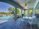 Covered patio with seating area overlooking the community pool and landscaped grounds at 1241 N Mcmullen Booth Rd, Clearwater, FL 33759