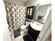 Cozy bathroom with decorative shower curtain, single sink vanity, and mirrored cabinet at 13924 Pathfinder Dr, Tampa, FL 33625