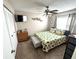Bright bedroom featuring a ceiling fan, carpet, closet, and a sunny window at 13924 Pathfinder Dr, Tampa, FL 33625